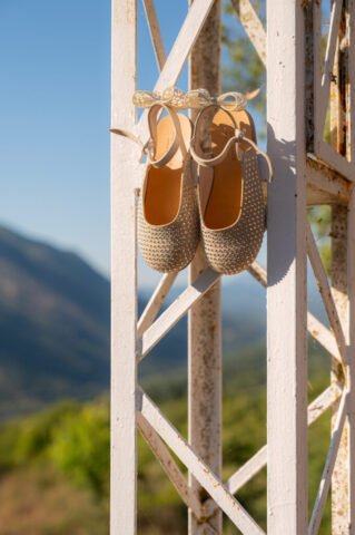 Brand new shoes on a rusty white iron construction. Photo is taken during a christening in Preveza, Greece