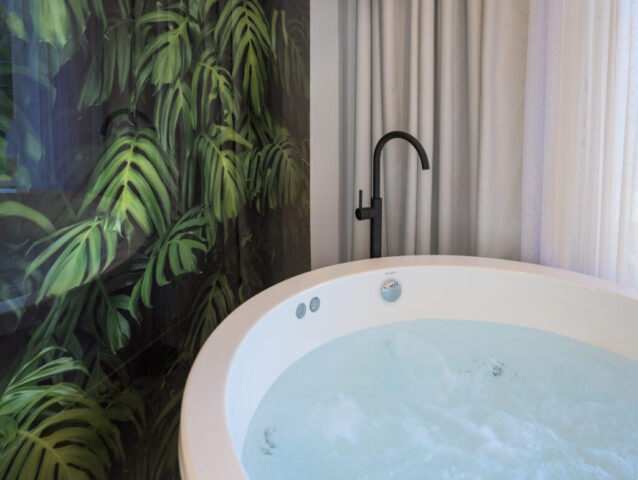 Modern bedroom with walk-in glass shower and jacuzzi and wonderful views of Parga, Greece